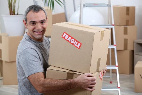 Moving boxes and furniture being loaded for transport in Ilford