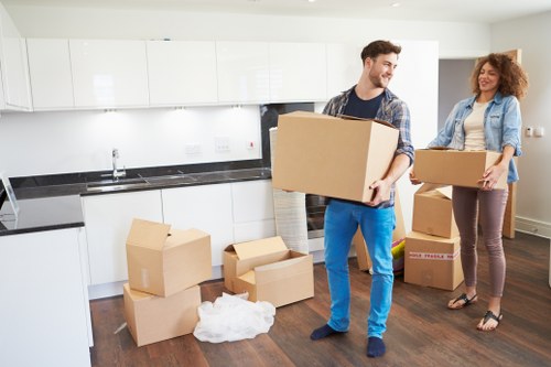 Professional movers loading household items for transport in Ilford