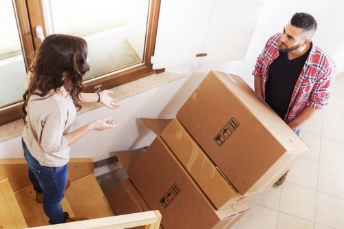 Removal team handling boxes and furniture for an Ilford property move