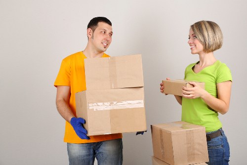 Movers using safe lifting techniques during a relocation job